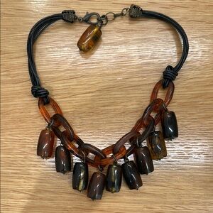 Beautiful leather, resin and metal necklace. Tortoise color beads